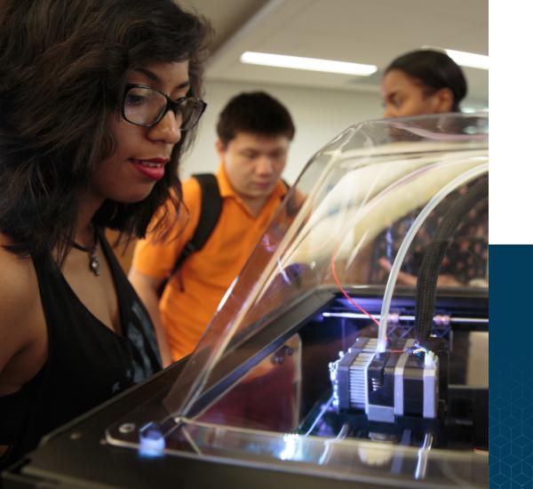 woman looking at 3D printer